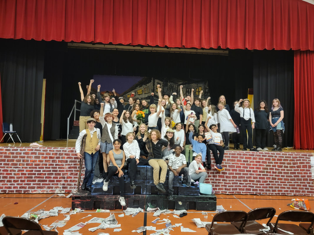 The full company on stage